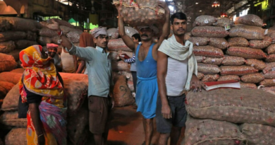 Traders carrying sacks of vegetables