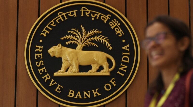 A woman walks past the Reserve Bank of India (RBI) logo inside its headquarters